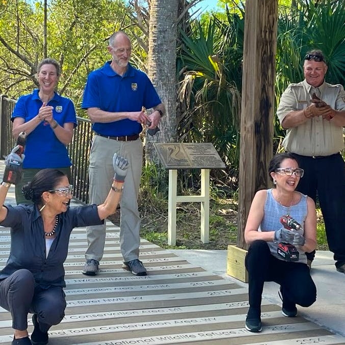 U.S. Secretary of the Interior Deb Haaland and Assistant Secretary of the Interior Shannon Estenoz are joined by other Department of the Interior staff on Monday to add a plank commemorating the designation of the Everglades to Gulf Conservation Area at the boardwalk of Pelican Island National Wildlife Refuge in Vero Beach, Florida.